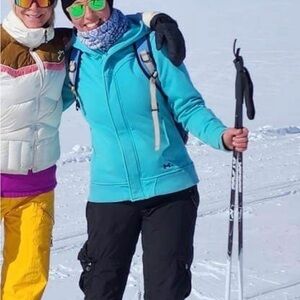 Turquoise/blue Under Armour storm jacket.